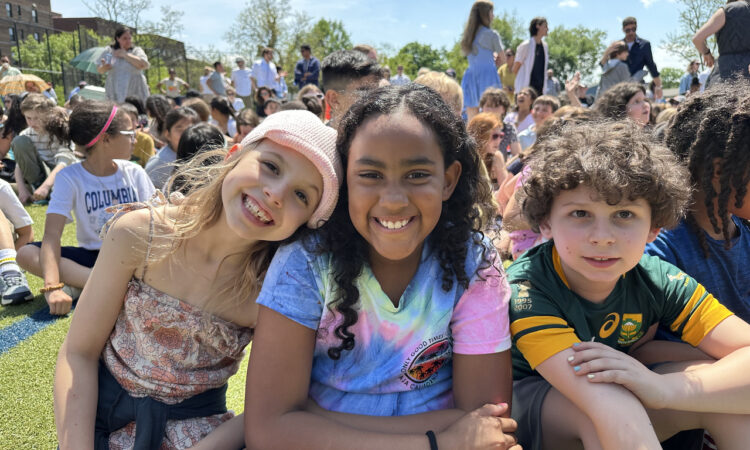 ethical culture fieldston school; fieldston lower students smile together at Spring Festival