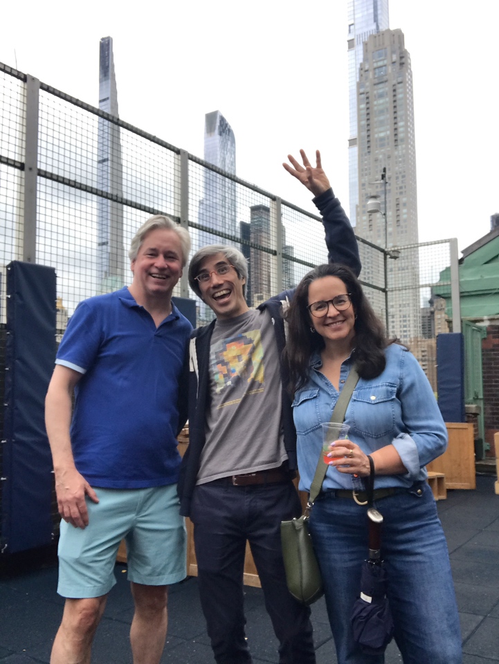 ethical culture fieldston school ethical culture parents smile together on the rooftop at Spring Fest community celebration.