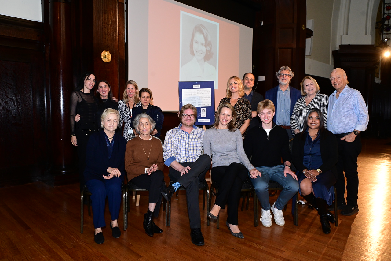 Family and friends of Lucy Simon Levine ’58 pose on stage in the Ethical Culture auditorium following the assembly.