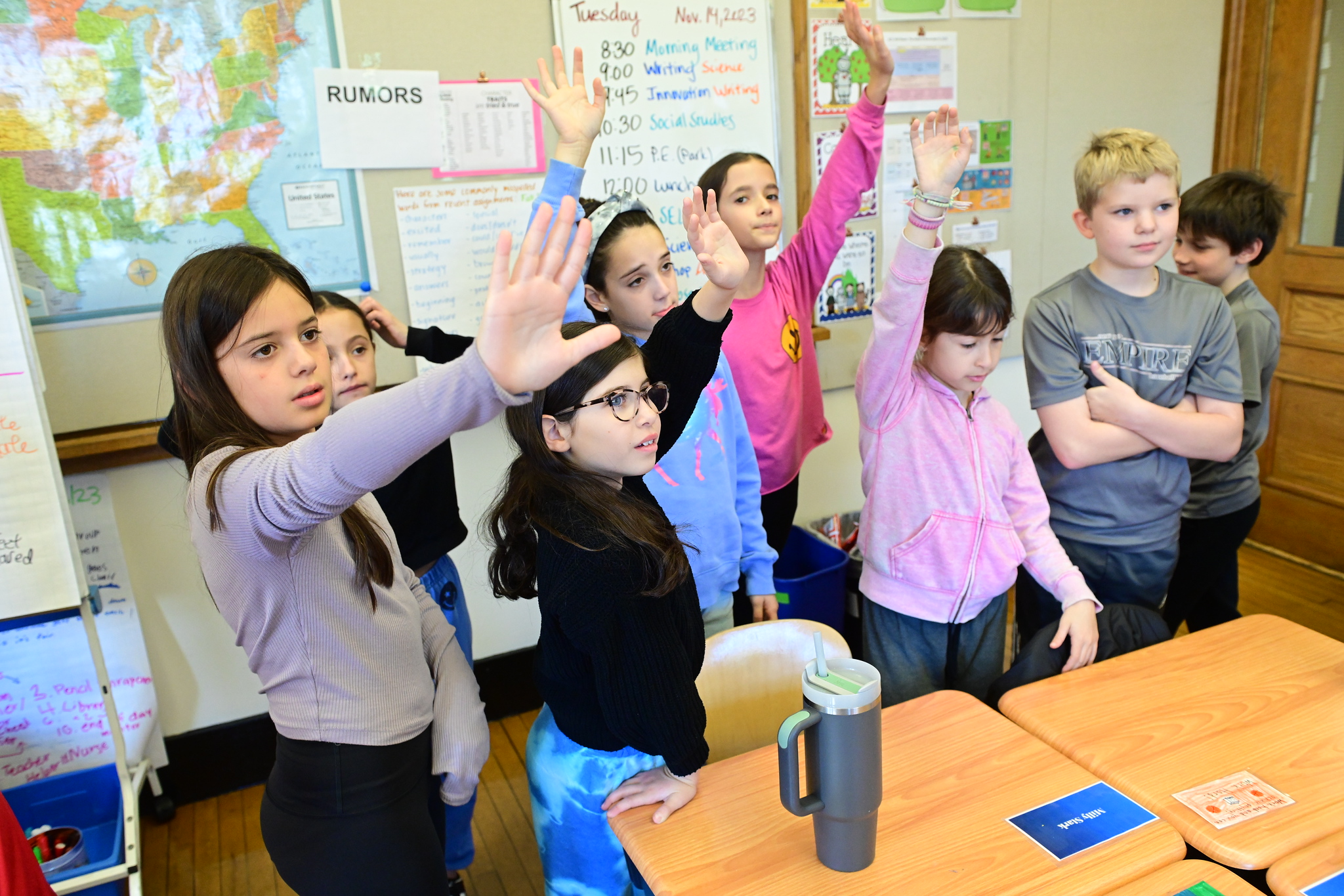 Students raise hands while discussing rumors and gossip as part of Owning Up curriculum at Ethical Culture.