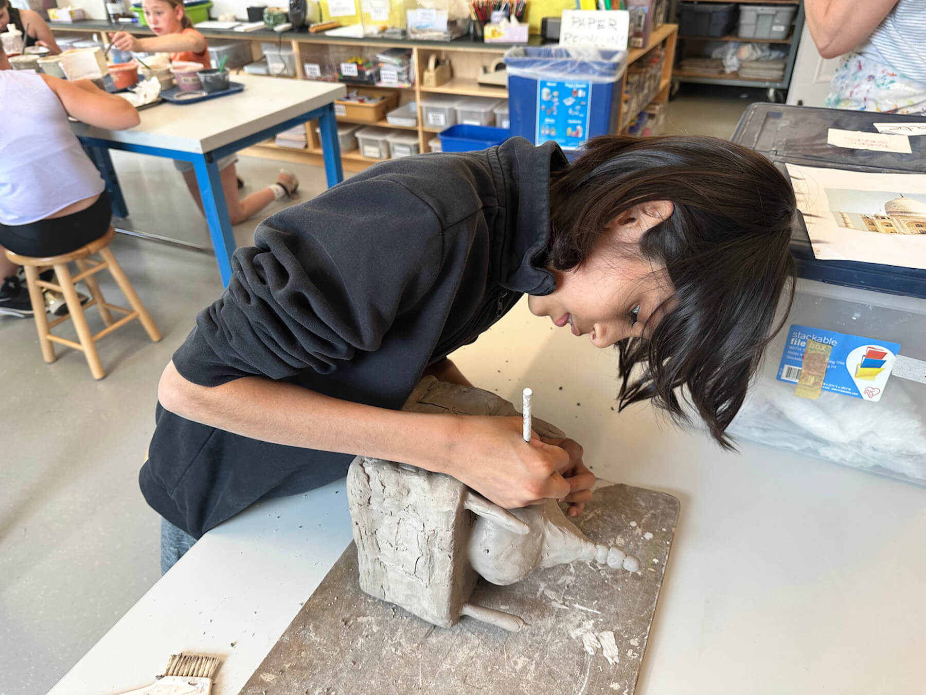 Ethical Culture 5th Grader works to shape his clay model of the Taj Mahal.
