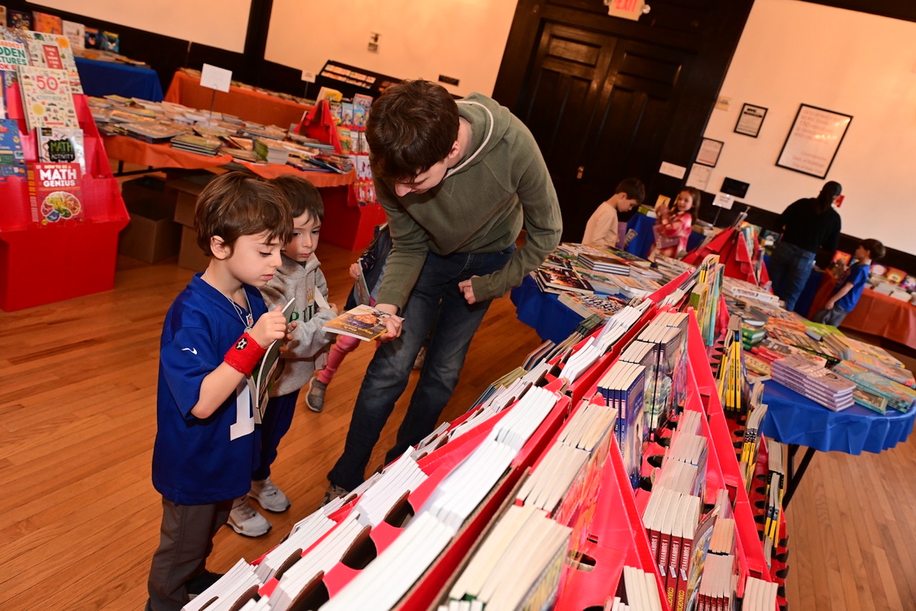 Students and adults teachers browse for books at the Ethical Culture Book Fair.