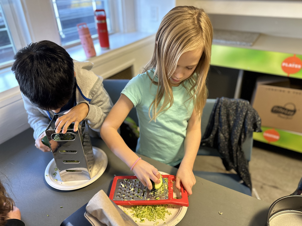 Ethical Culture student cooks at after school class.