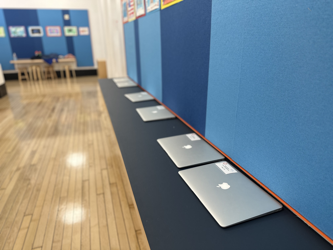Computers sit in a row in Ethical Culture hallway.