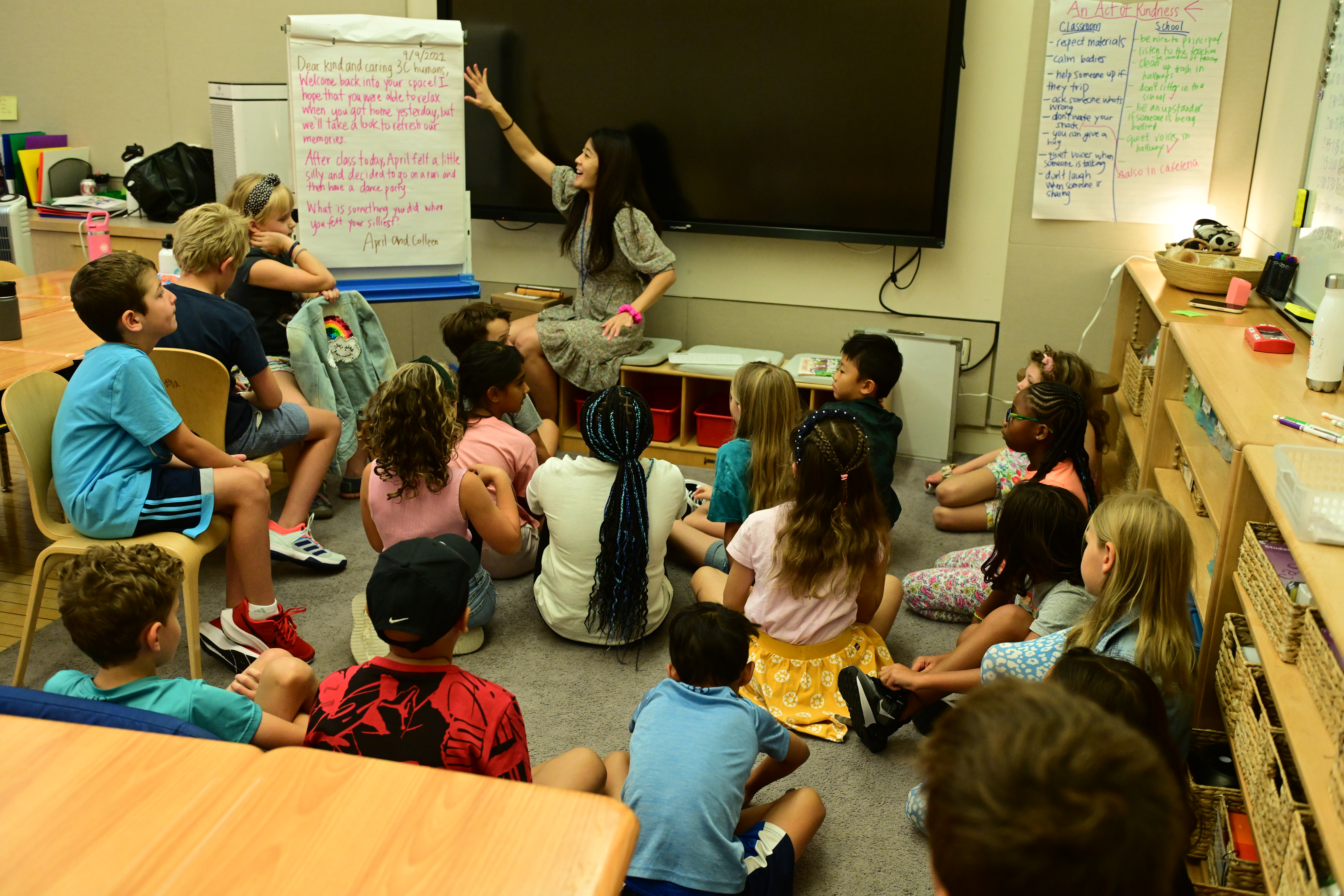 Ethical Culture students gather in a classroom and look over a welcome note from their teacher in the first week of School