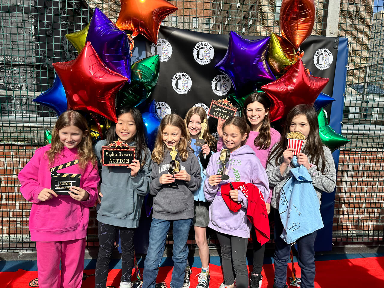 Ethical Culture students pose together at cast party for 4th Grade play. 