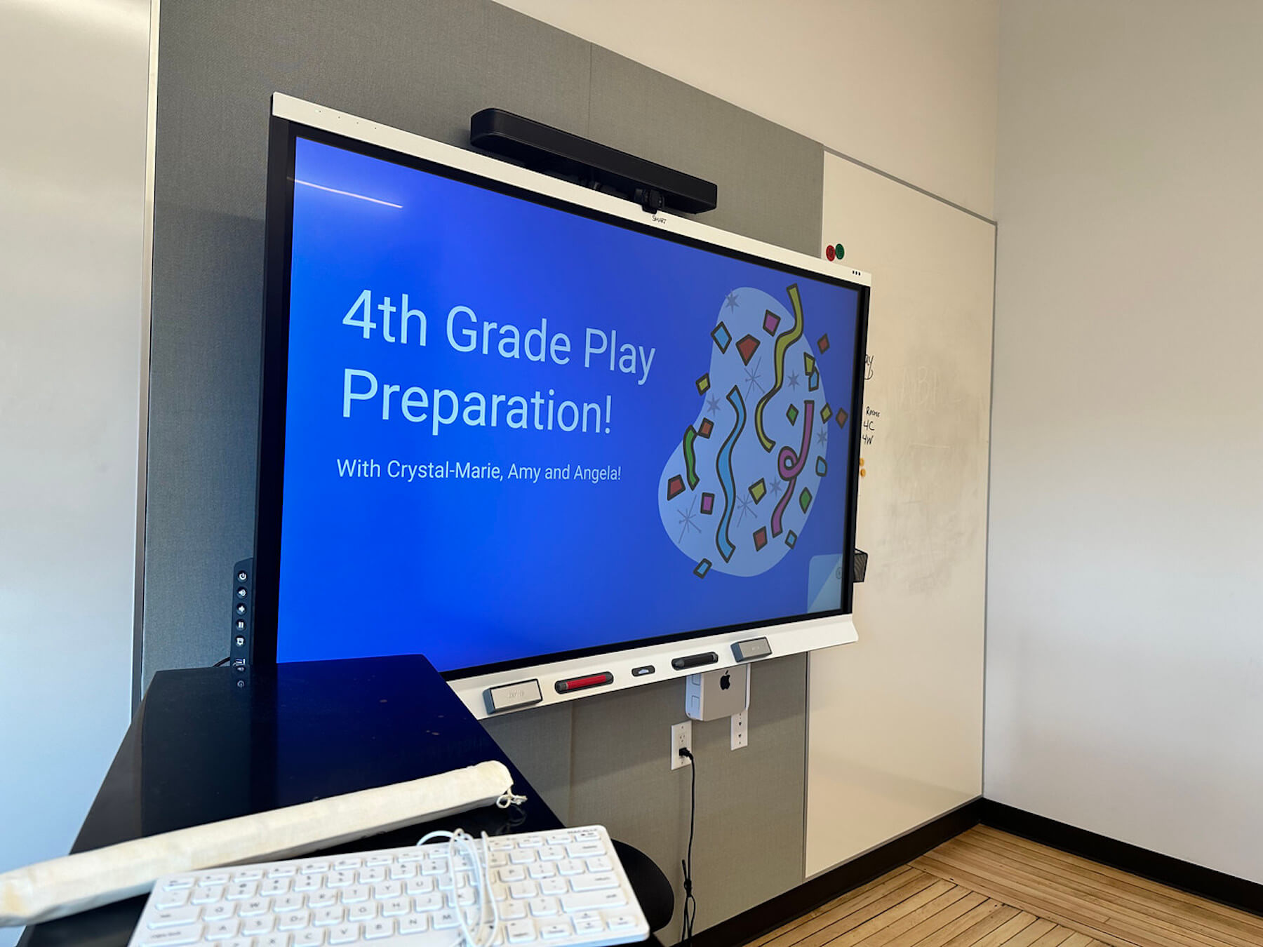 TV display that reads, "4th Grade play preparation"