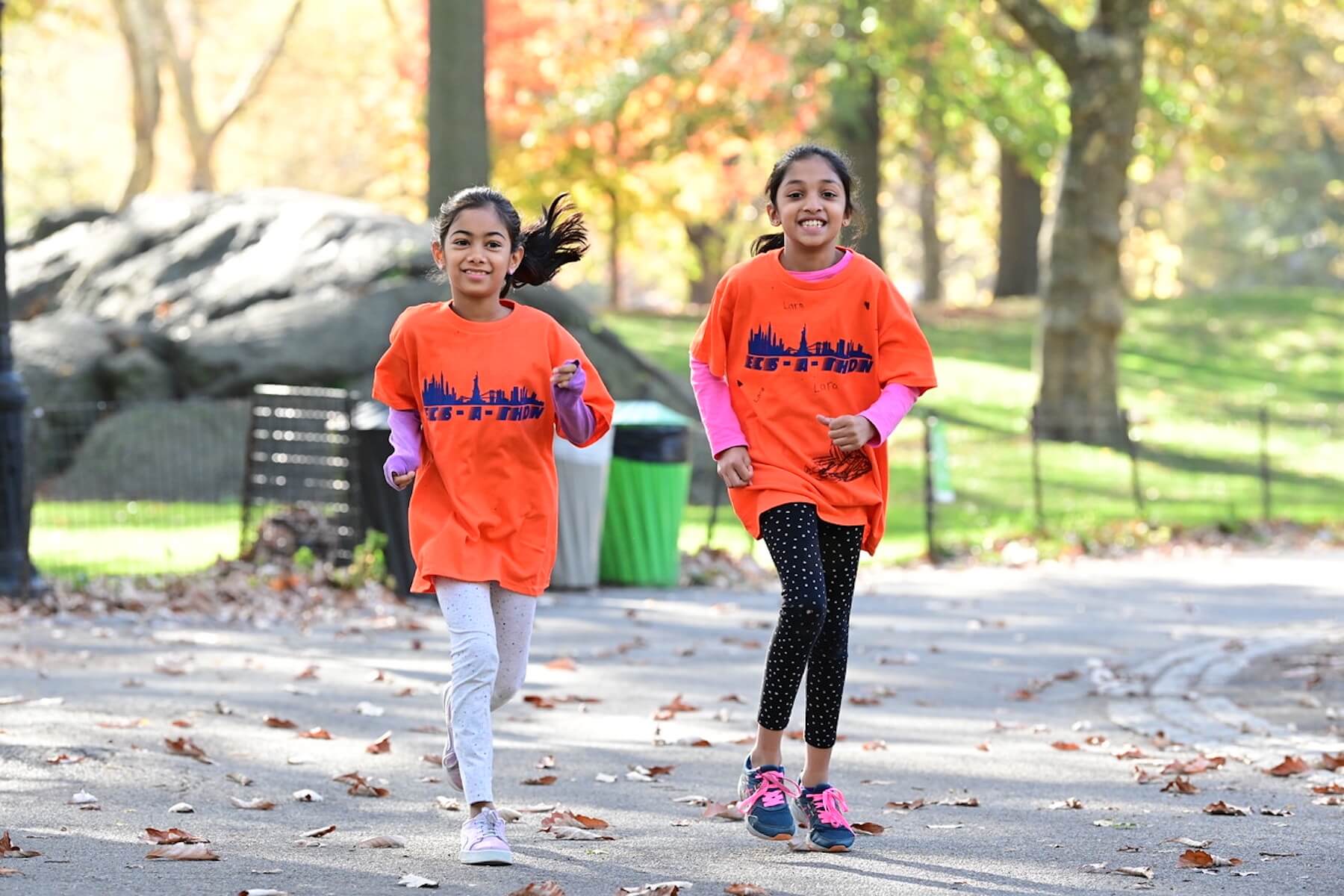 Two students at Ethical Culture run together at ECS-a-Thon in Central Park.