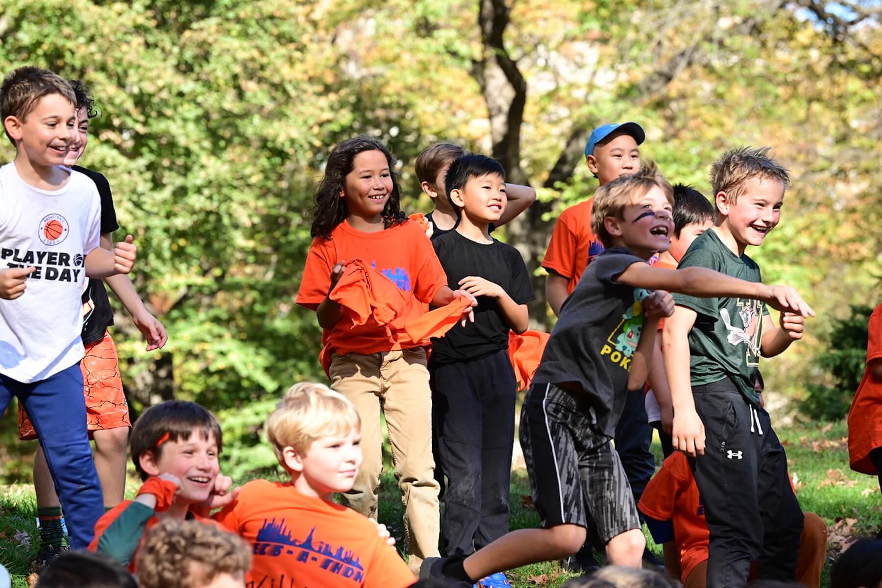 Group of students stand on hill smiling after their race has ended.