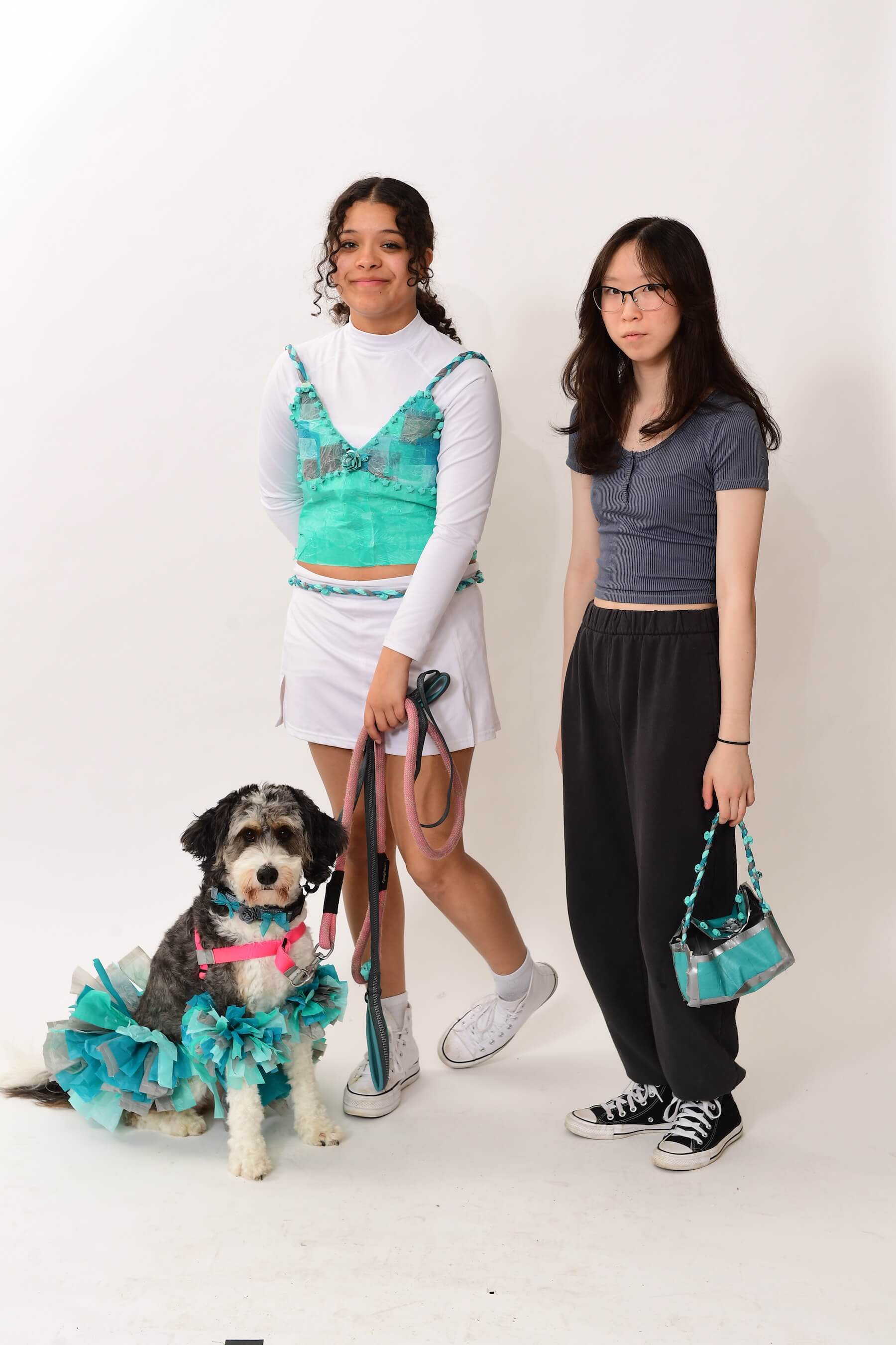 Two Ethical Culture Fieldston Upper School students and a dog model at the Fashion Show.