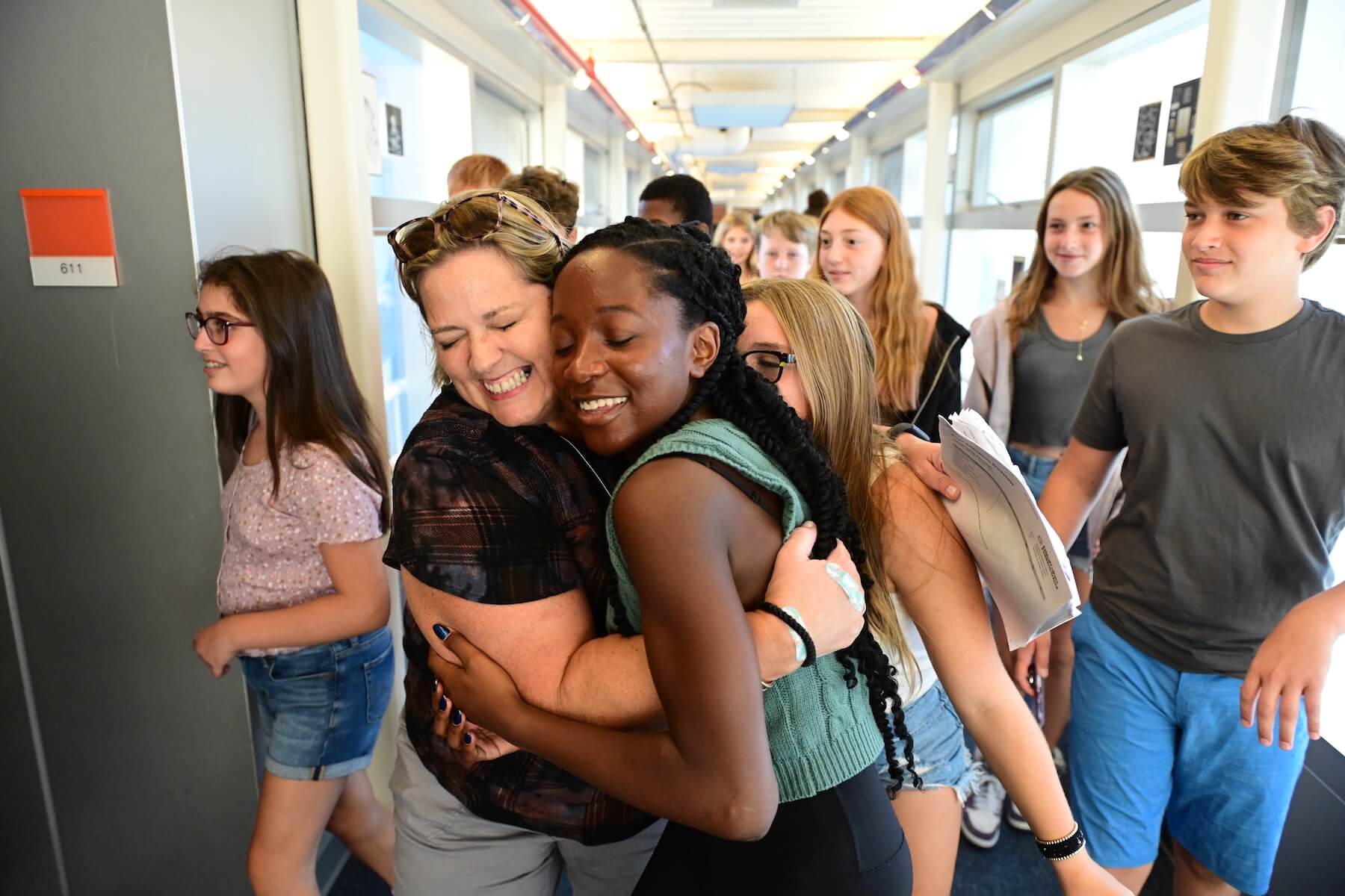 Ethical Culture Fieldston School Fieldston Middle student embraces teacher in a hug