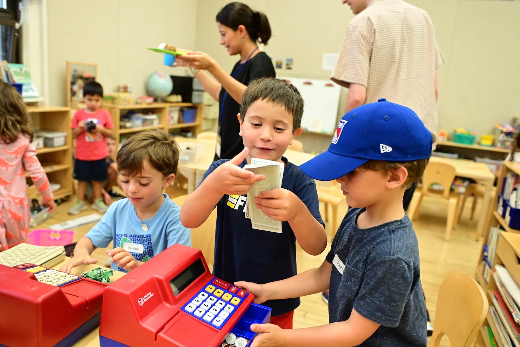 Ethical Culture Fieldston School Ethical Culture students share play money in class