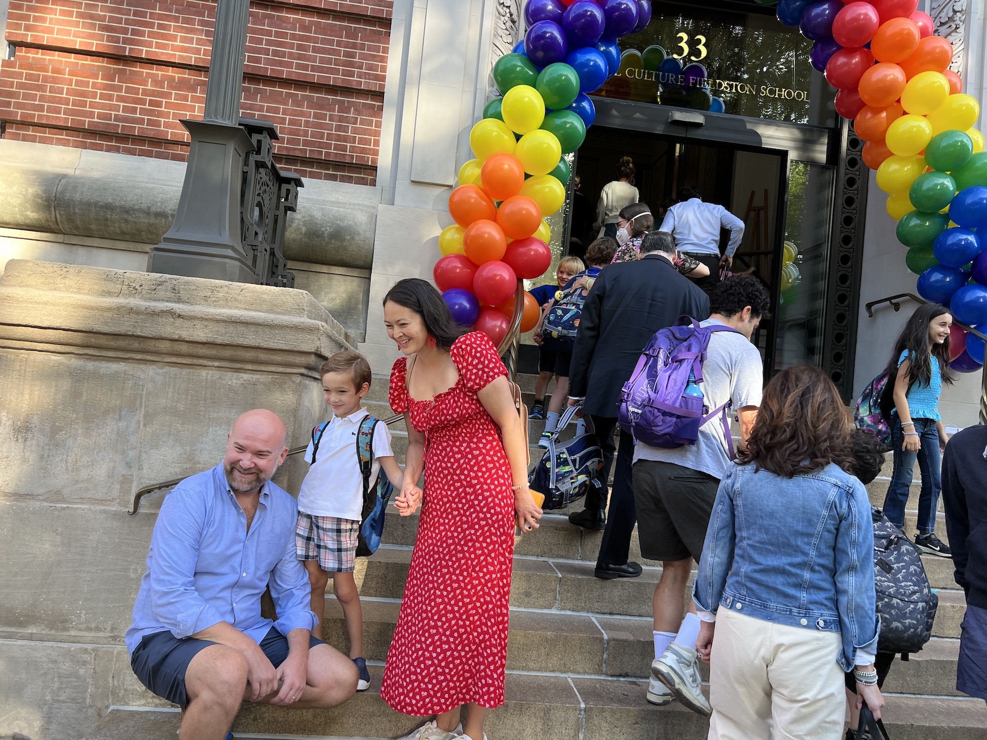 A family poses for a photo on the steps of Ethical Culture on the first day of school