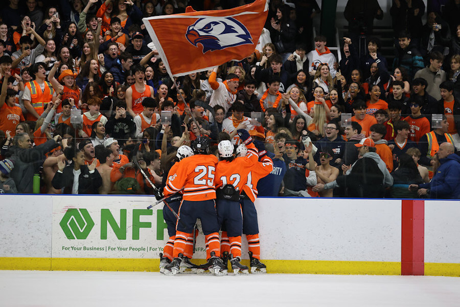 Ethical Culture Fieldston School Upper School hockey students celebrate a victory on the ice rink