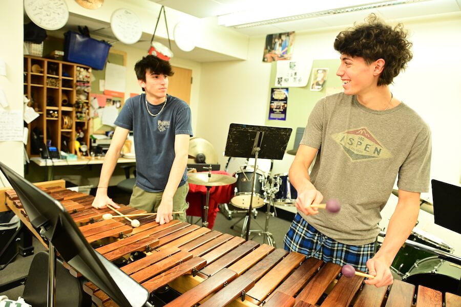 Ethical Culture Fieldston School Upper School students play on xylophone during percussion class
