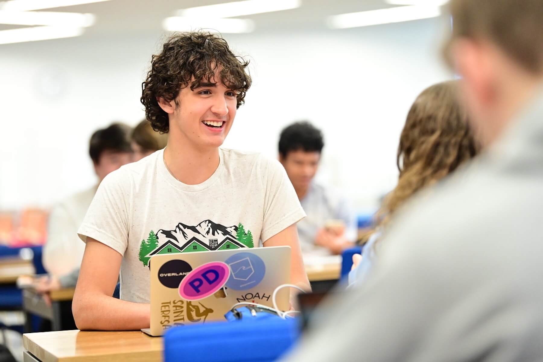 Two Ethical Culture Fieldston School Upper School students smile at each other during study time