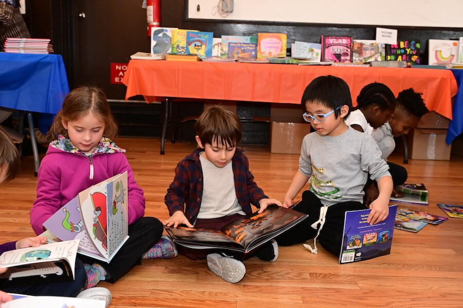 Ethical Culture Fieldston School students sharing books at the Ethical Culture book fair