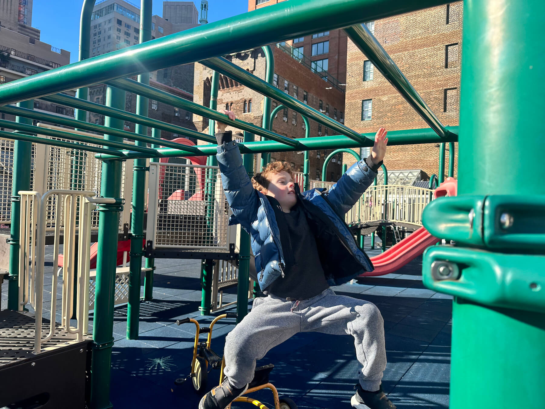 Ethical Culture Fieldston School student swings from bars on the Ethical Culture roof