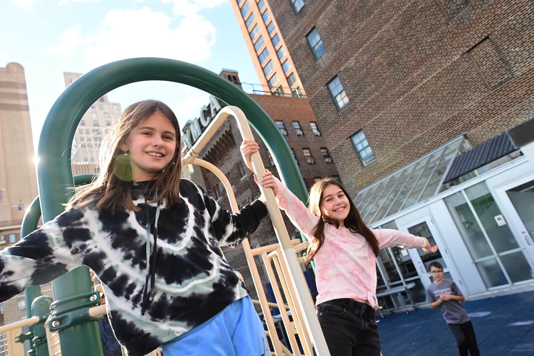 Ethical Culture Fieldston School_Feel Good Photos_Ethical Culture students swing on the playground bars