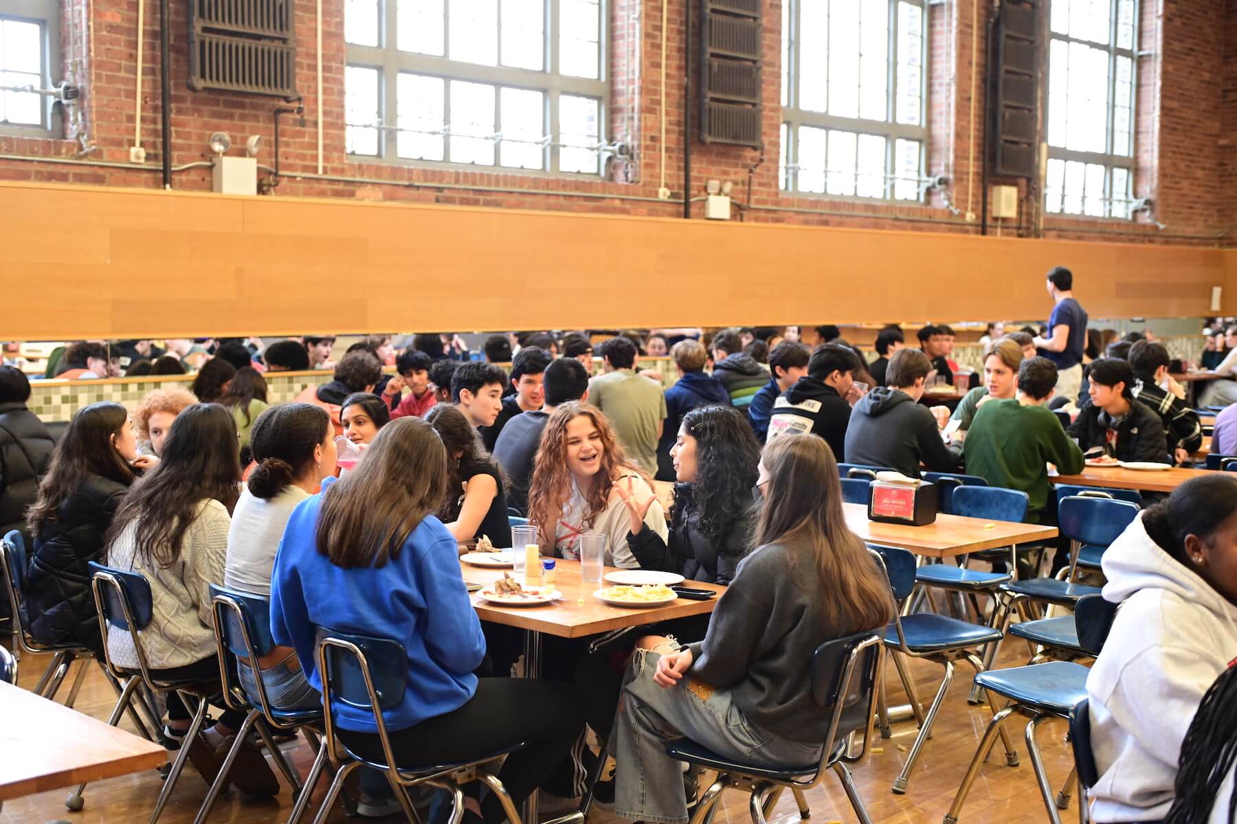 Ethical Culture Fieldston School students engaging in conversation during lunch at Fieldston Upper