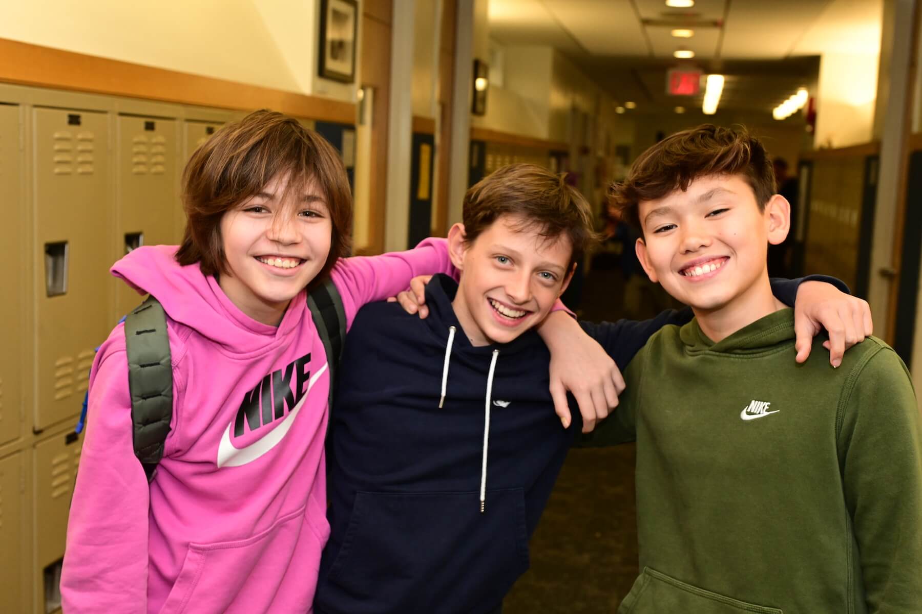 Ethical Culture Fieldston School students in Fieldston Middle smiling at the camera