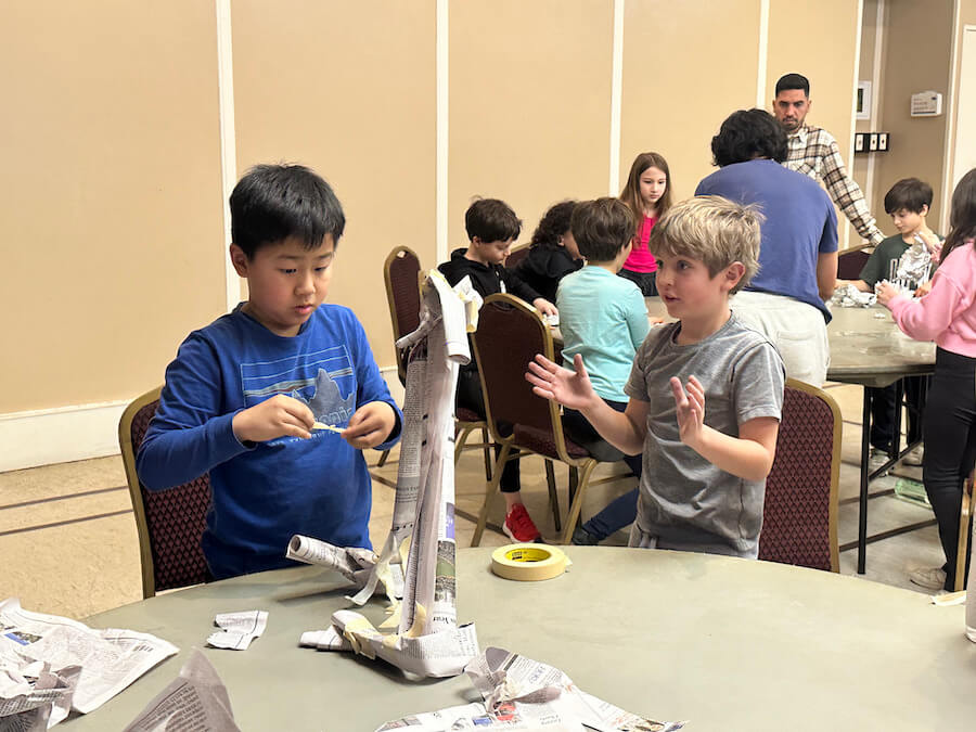 Ethical Culture Fieldston School students building with newspaper in engineering