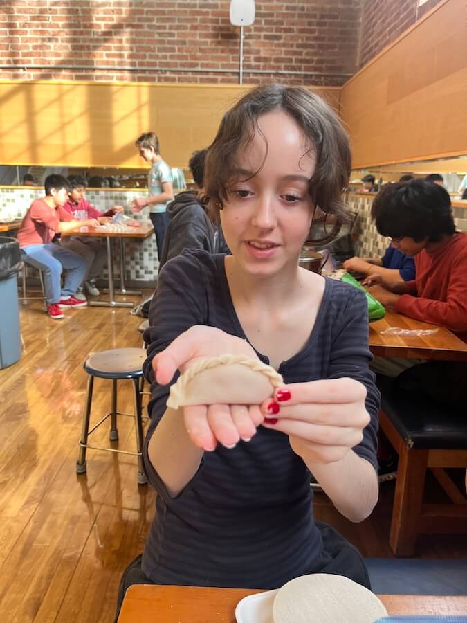 Ethical Culture Fieldston School Middle School student shares a handmade dumpling