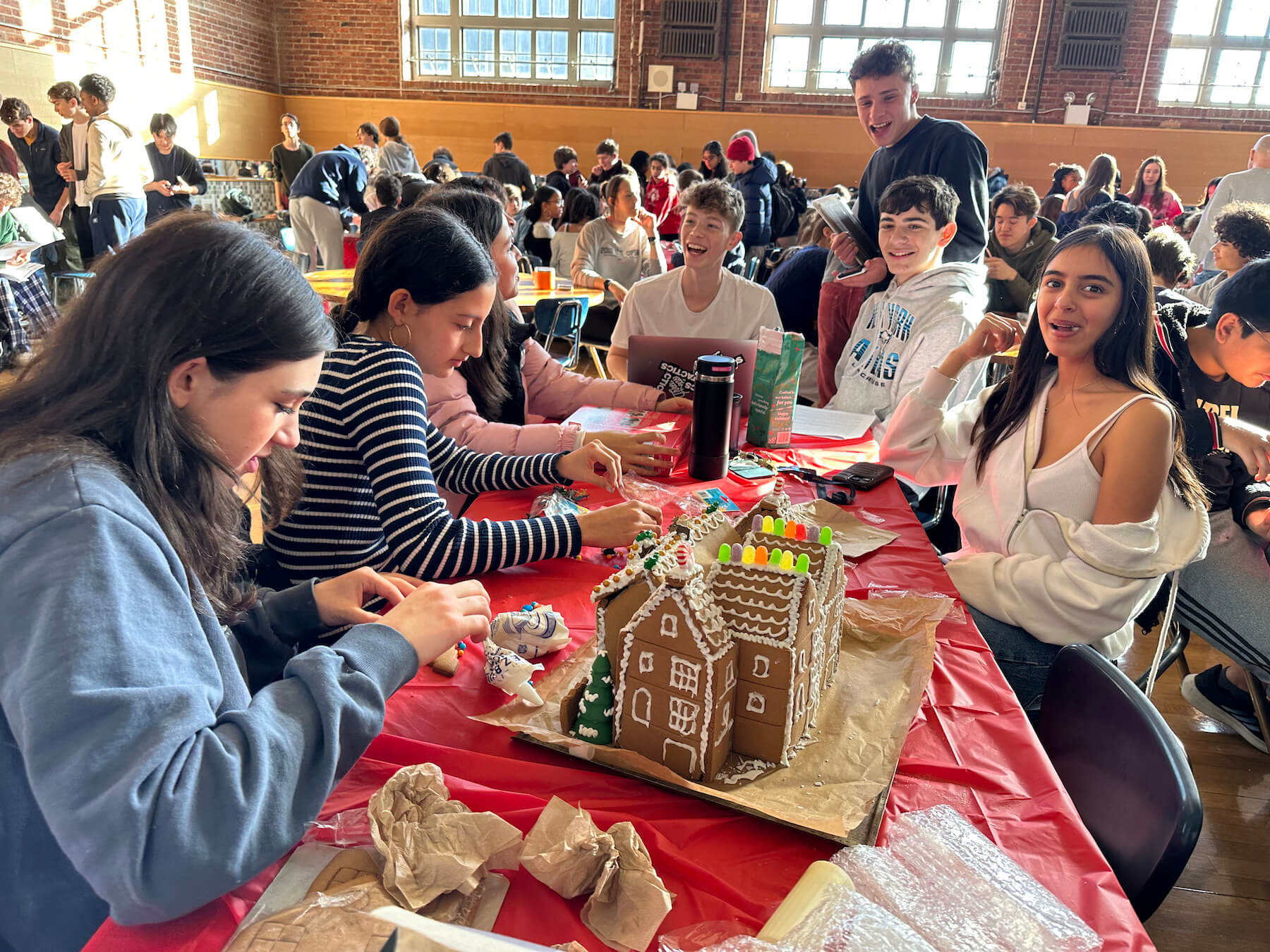 Ethical Culture Fieldston School students working together to build gingerbread house
