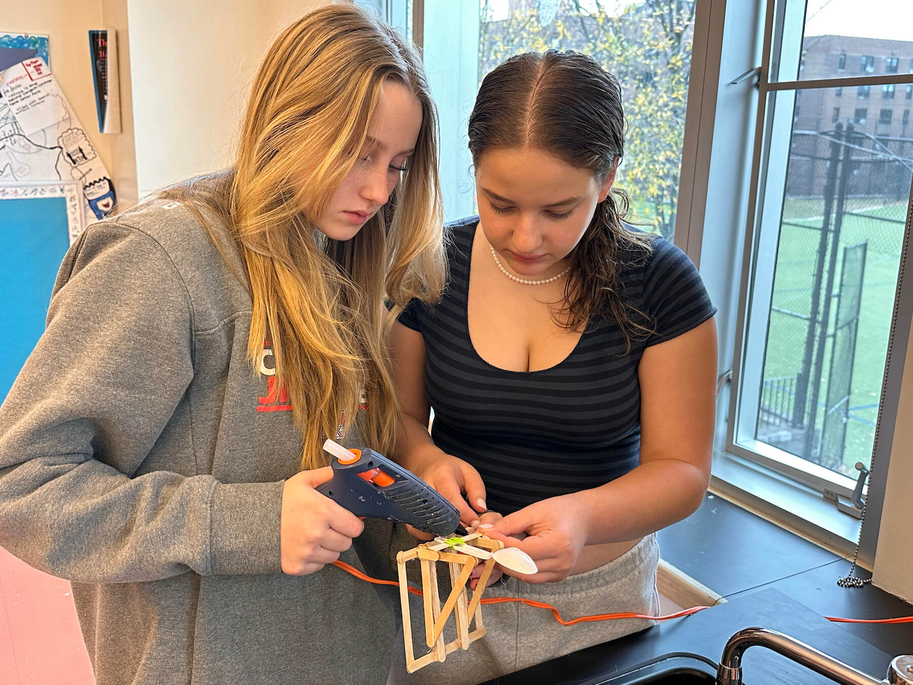 Ethical Culture Fieldston School students in Fieldston Middle building an experiment in science class