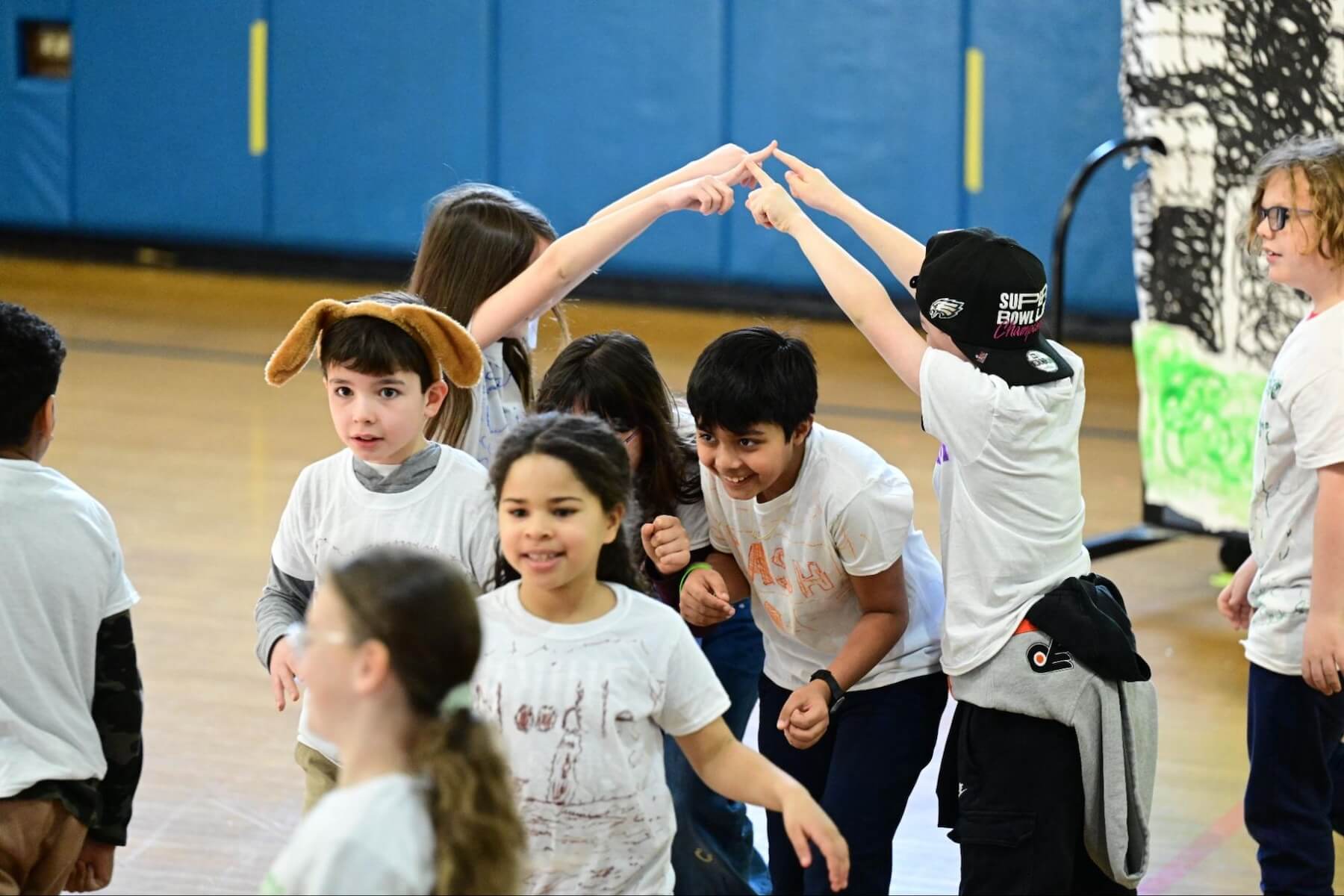 During a performance of the Ethical Culture Fieldston School 3rd Grade musical, two students make a bridge with their hands that other students run through.