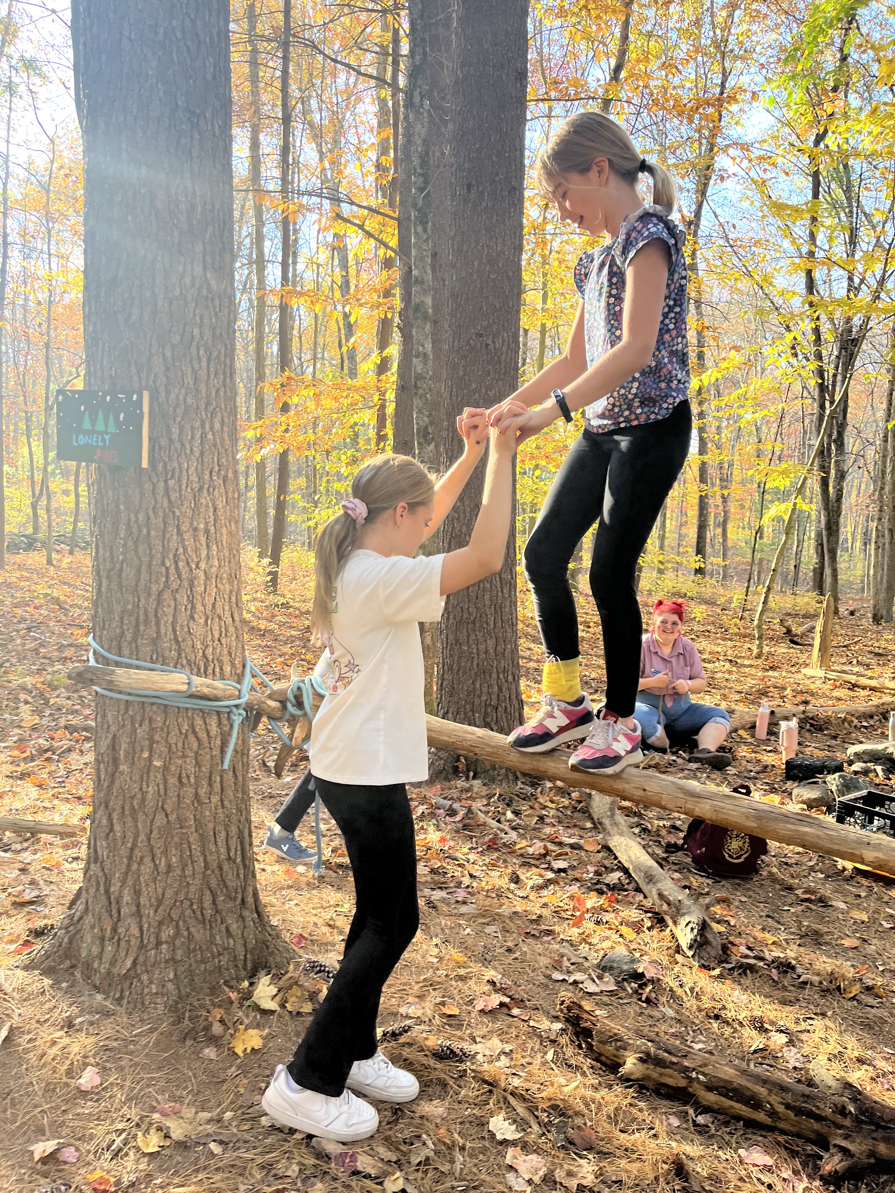 Fieldston Lower students help each other with ropes course at Nature's Classroom.