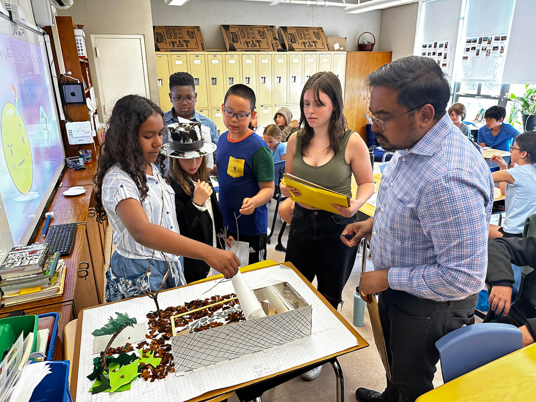 Assistant Principal Shawn Chisty observes student Shark Tank model.