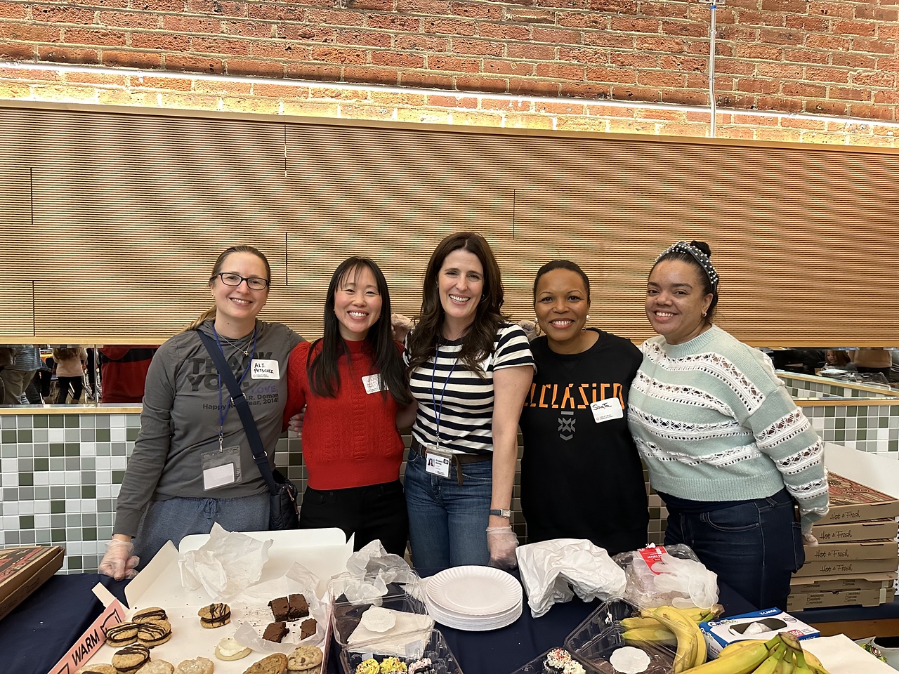 Parent/guardian volunteers pose at Fieldston Lower Family Game Night