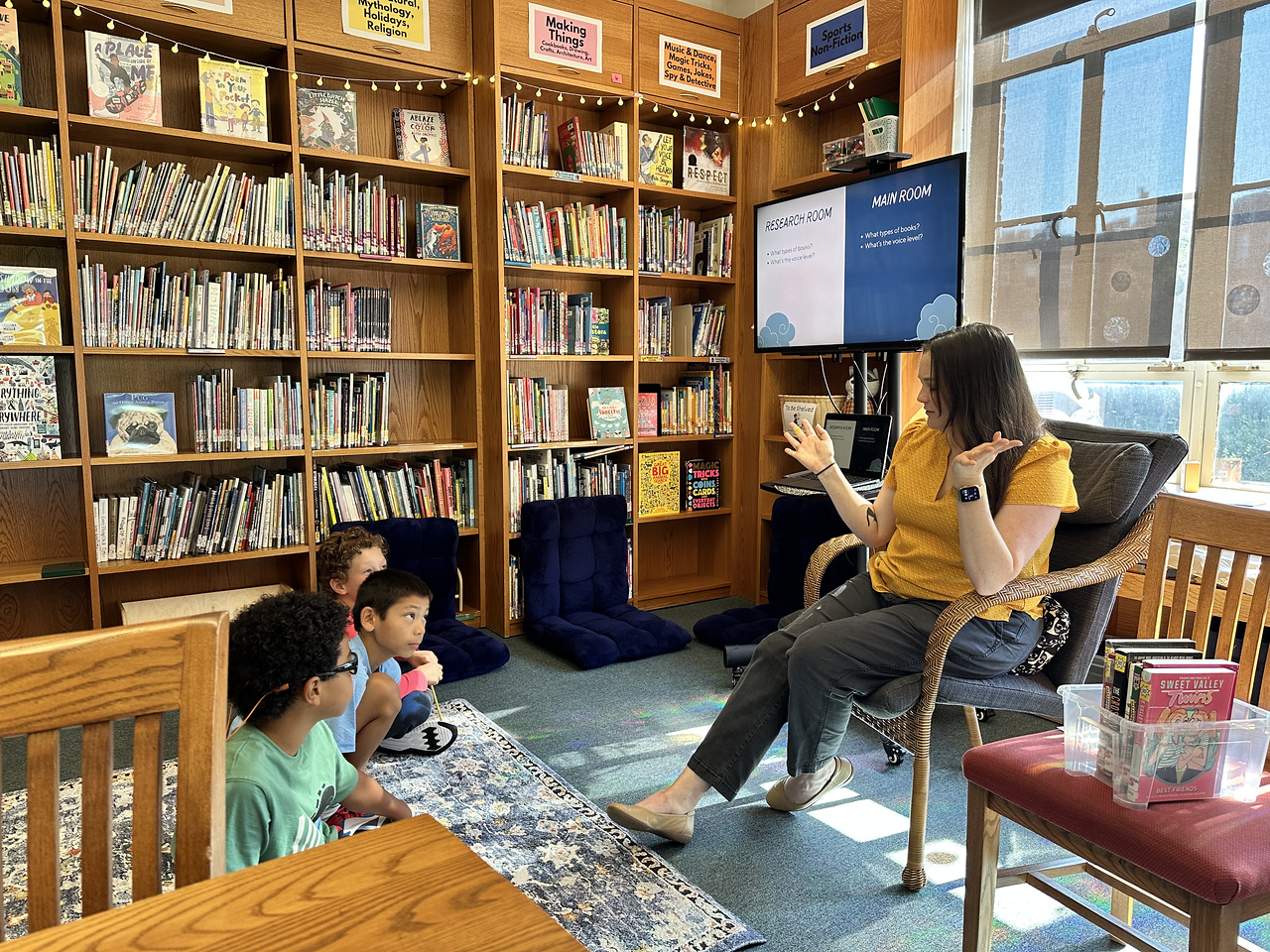 Students listen to librarian in Fieldston Lower library.