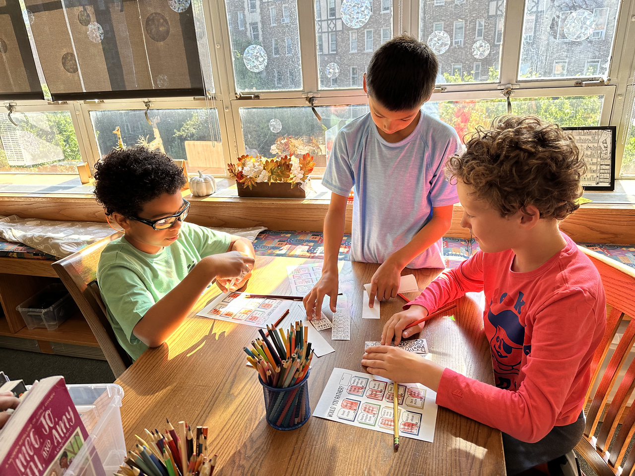 Fieldston Lower students work on a reading activity together in the library.