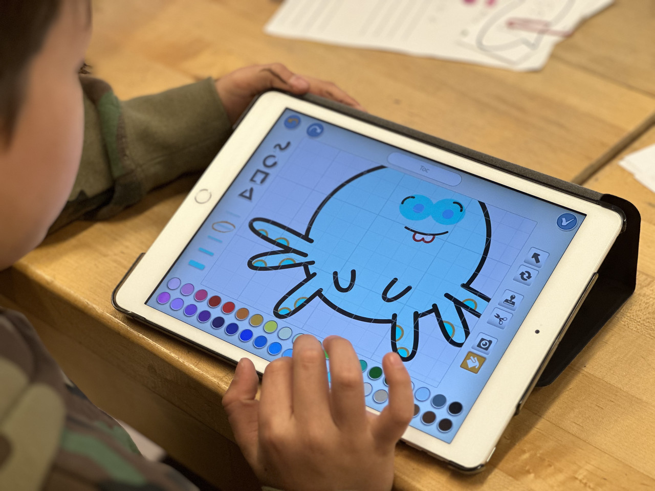 Close up of student work on iPad which displays a cartoon octopus.