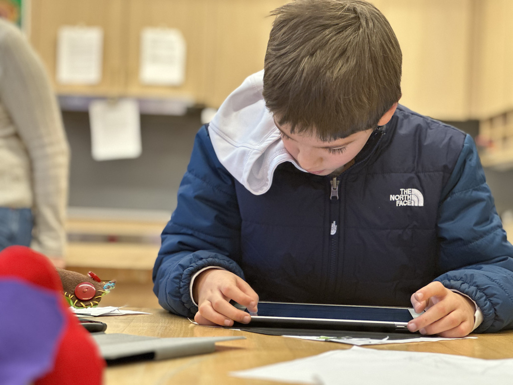 Fieldston Lower student works on his iPad in classroom.