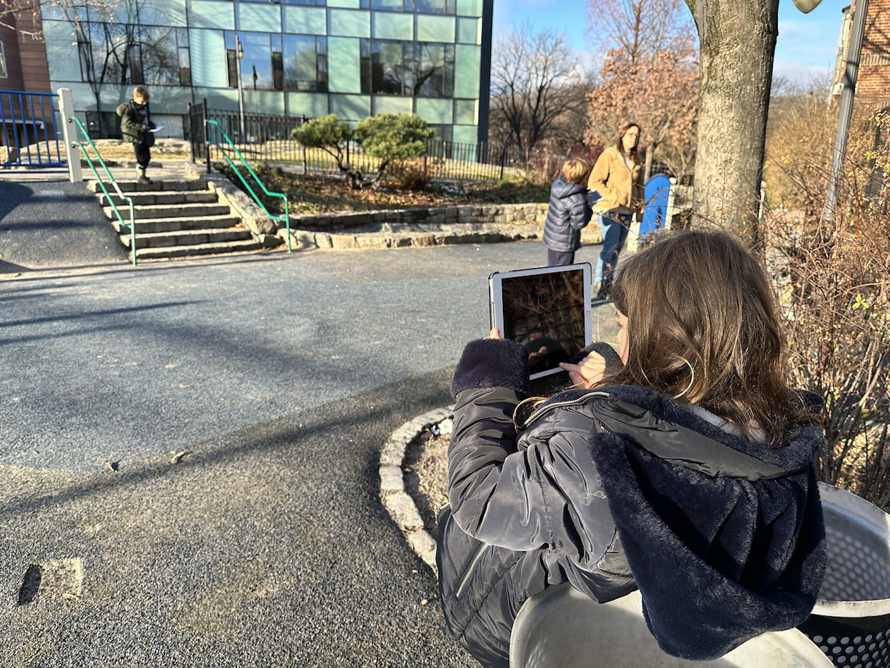 Student takes photo of playground outside using iPad at Fieldston Lower.