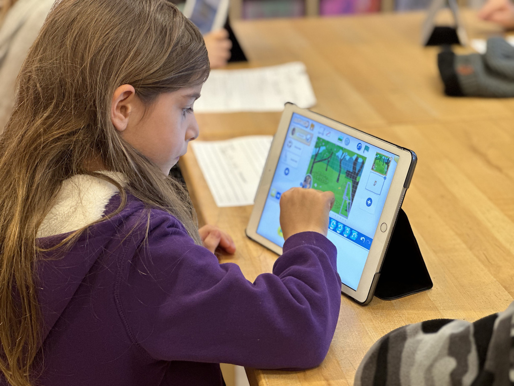 Fieldston Lower student makes adjustments to her video on iPad.