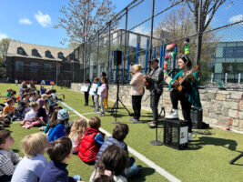 Fieldston Lower students look on as 5th Grade students and Spanish teachers lead them in singing 