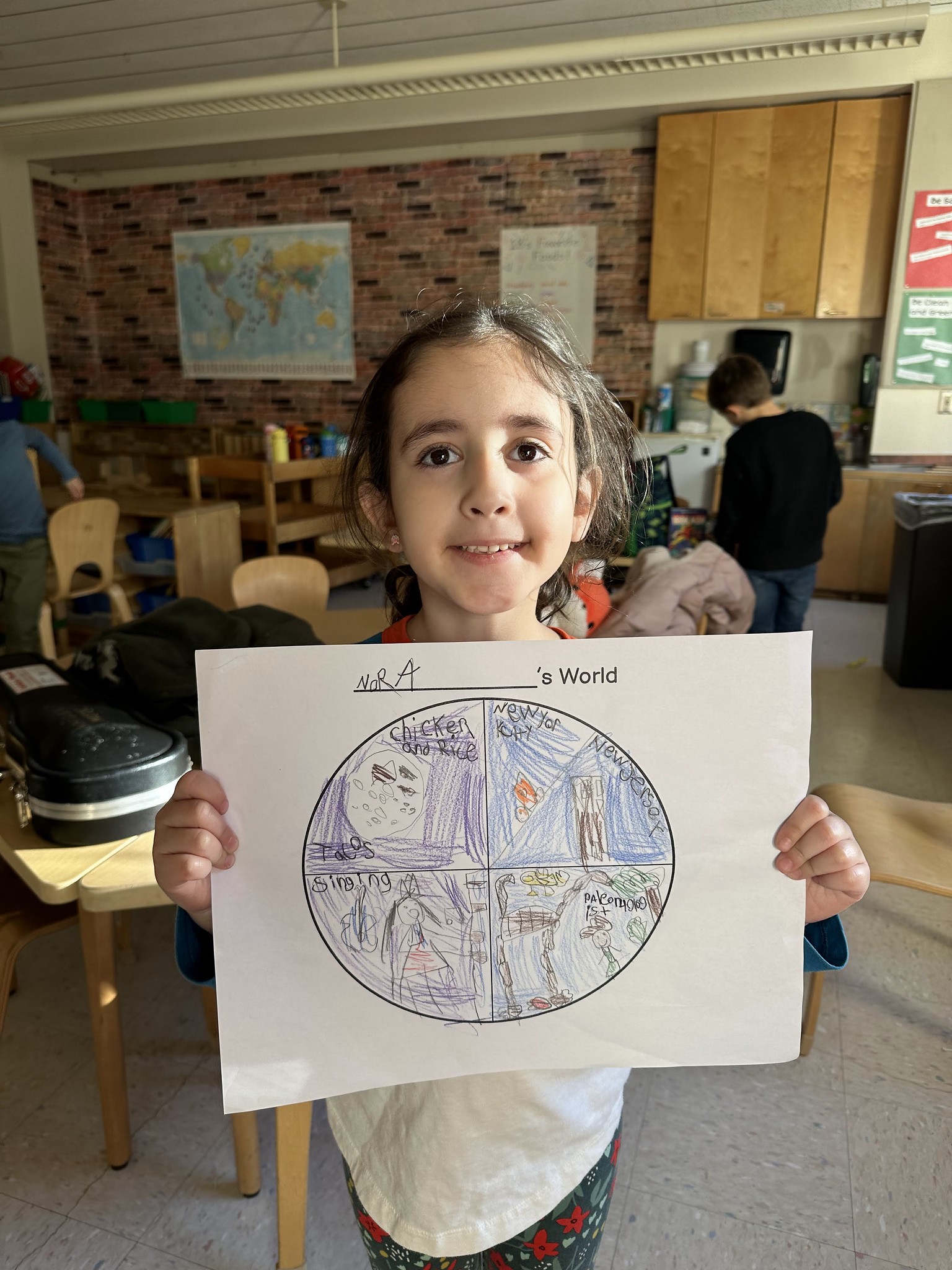 Fieldston Lower student poses with "My World" project.