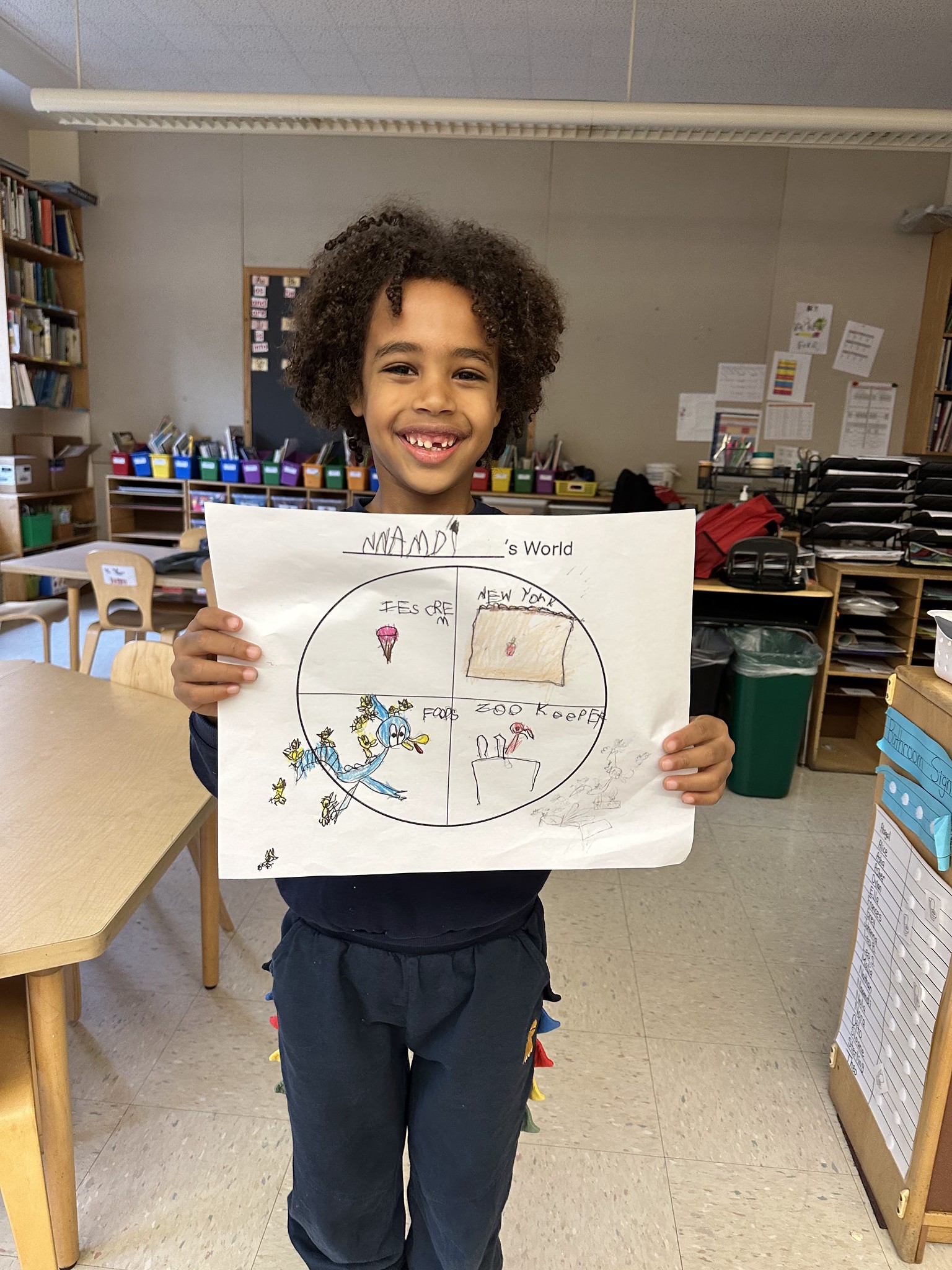 Fieldston Lower student poses with "My World" project.