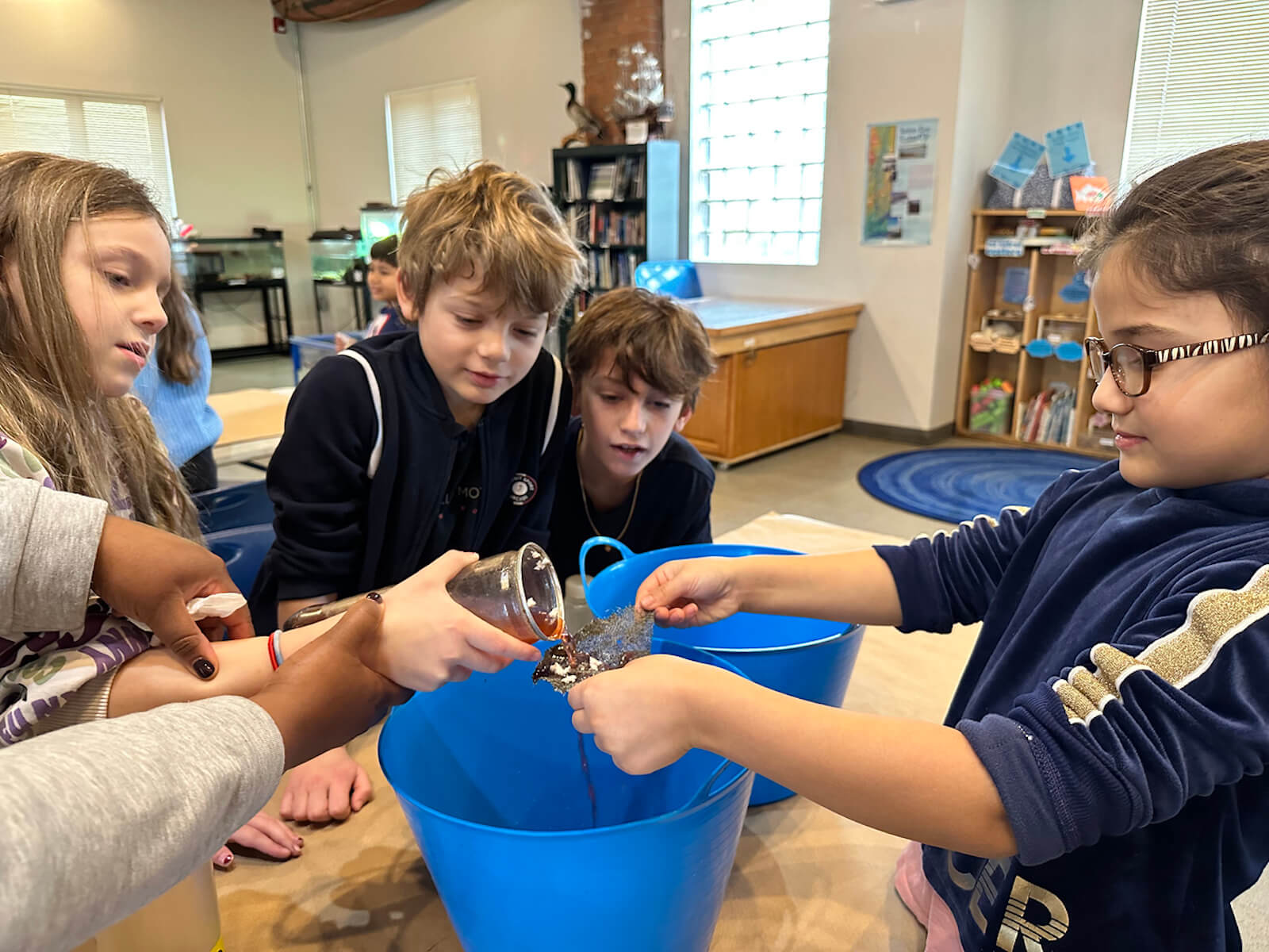 Fieldston Lower students collaborate to clean water at the Beczak Center.