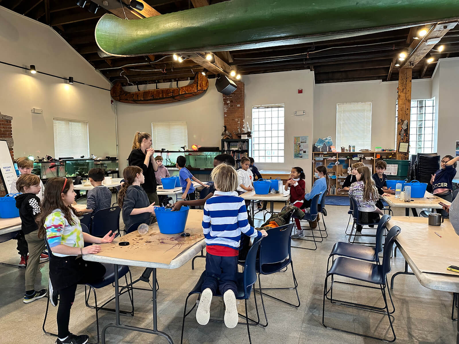 Fieldston Lower students listen to "Water Inspector" and filter dirty water using supplies such as a filter and cotton balls at the Beczak Center.