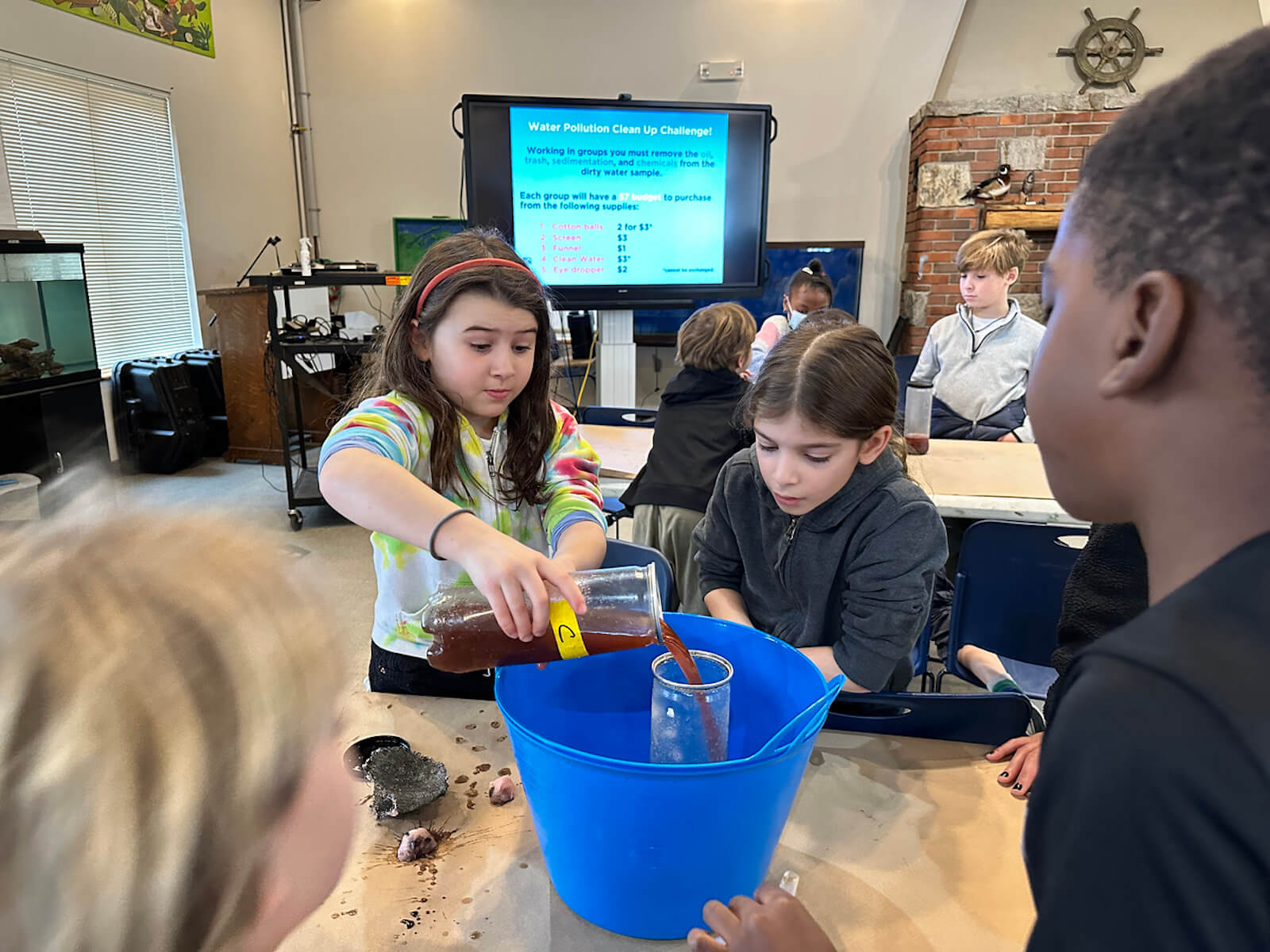 Fieldston Lower students filter dirty water using supplies at the Beczak Center.
