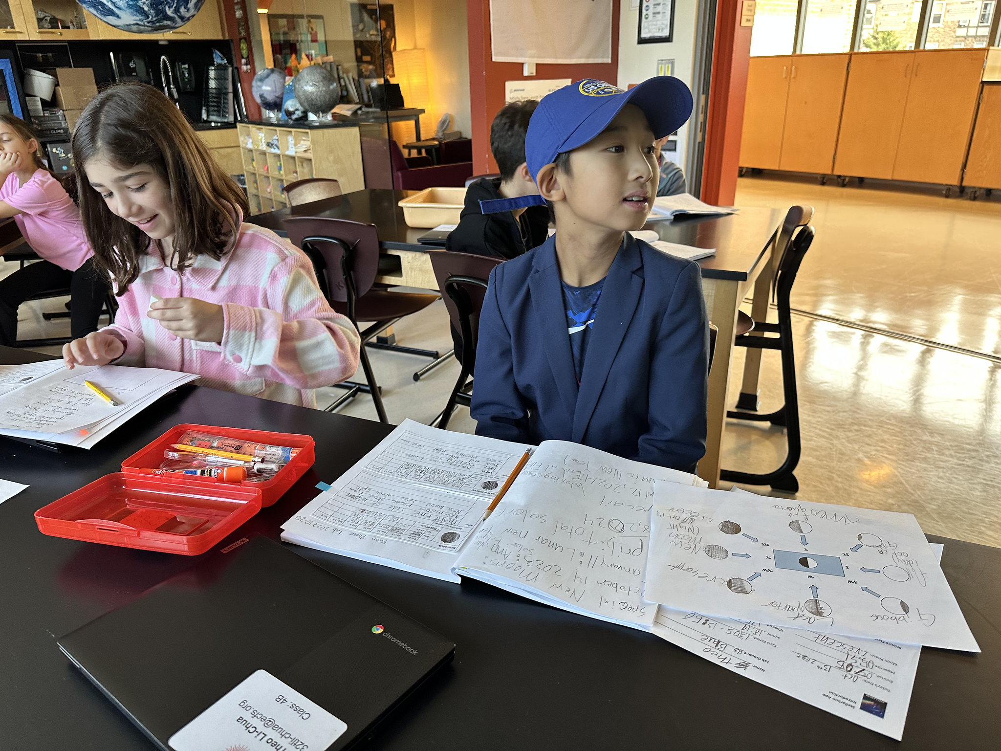 Fieldston Lower student looks up at the board during lesson on the moon phases.