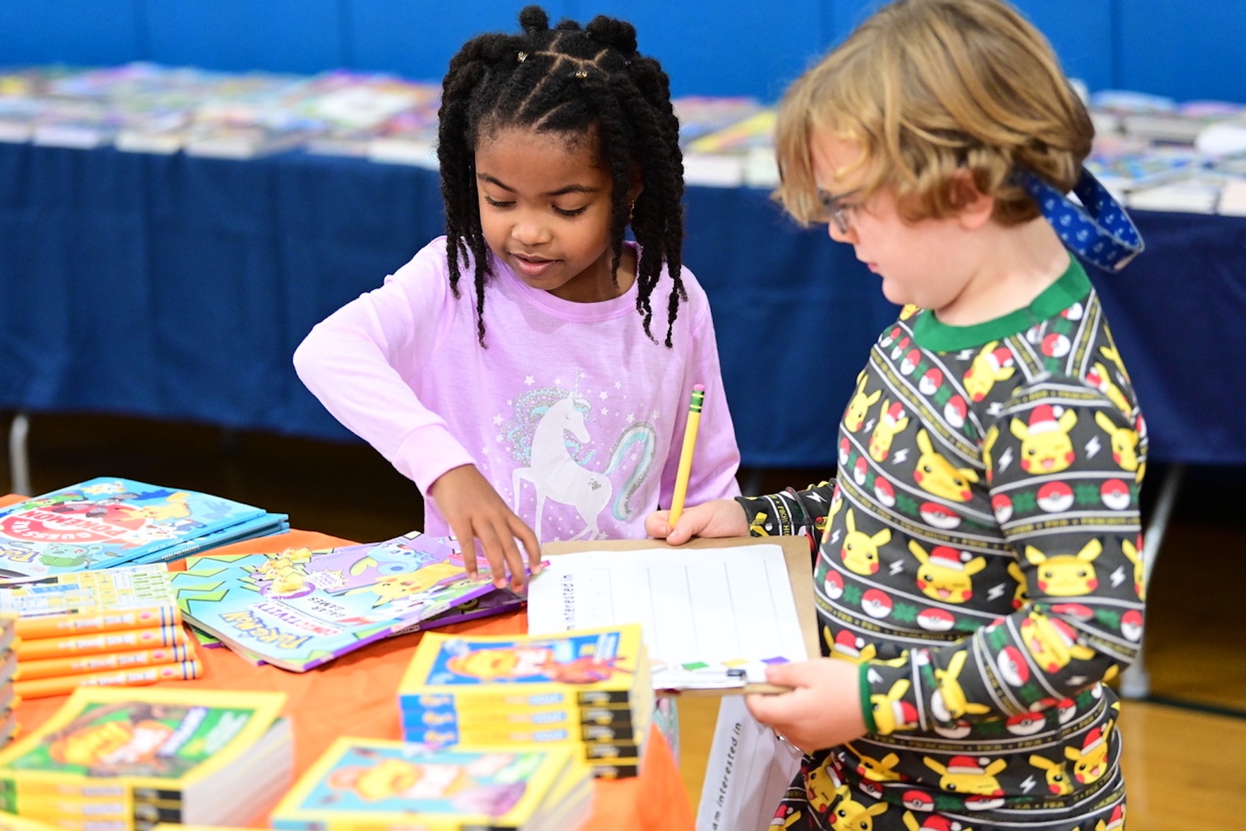 Two students at Fieldston Lower browse for books at the ECFS Celebration of Books.