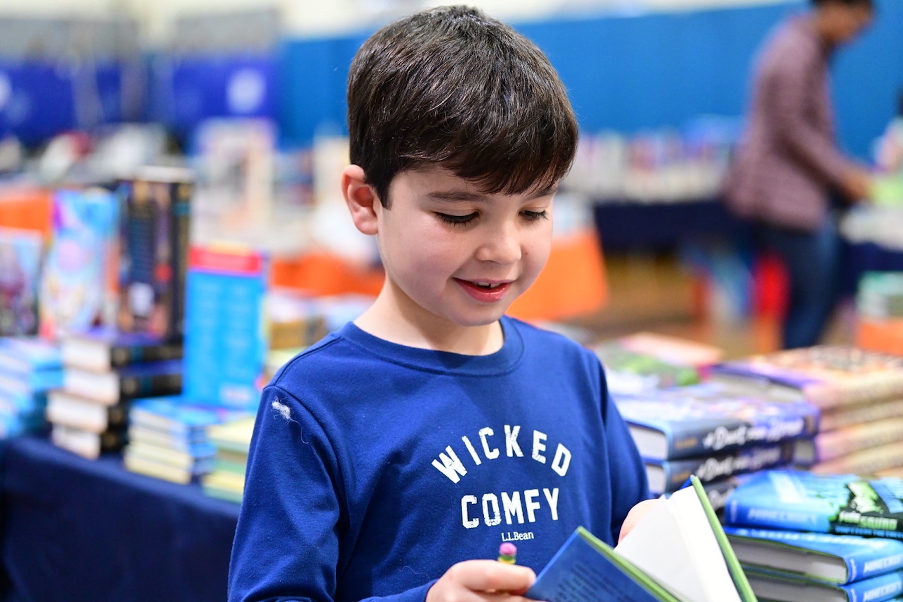 Student at Fieldston Lower browses for books at the ECFS Celebration of Books.