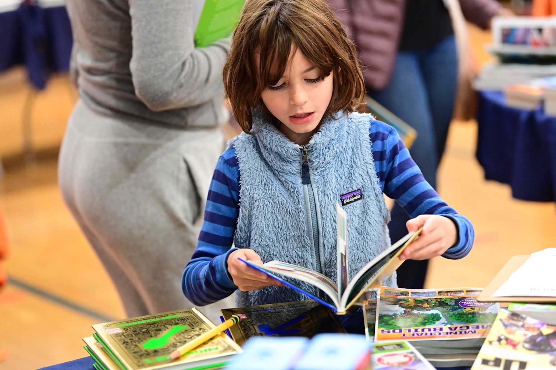 Student at Fieldston Lower browses for books at the ECFS Celebration of Books.