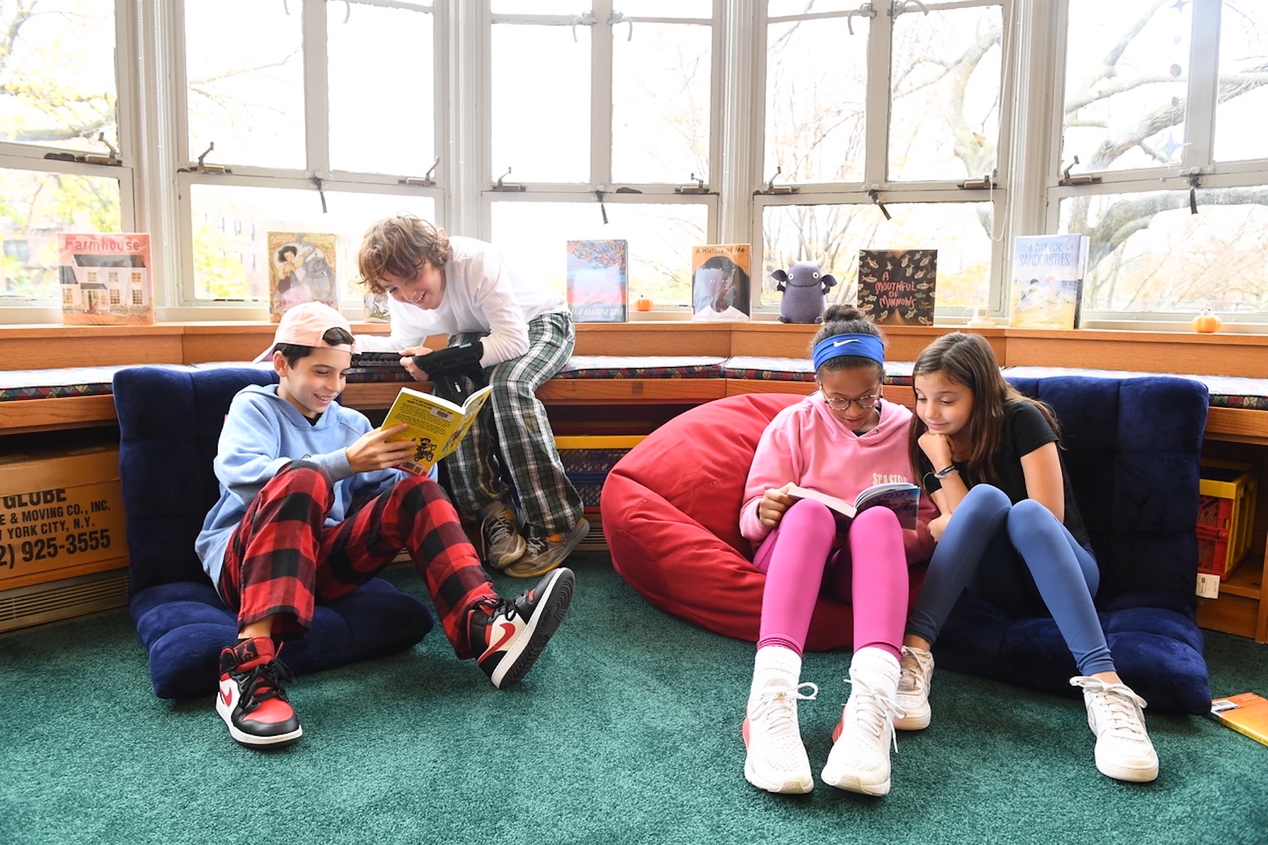 Four students read together in the Fieldston Lower library.